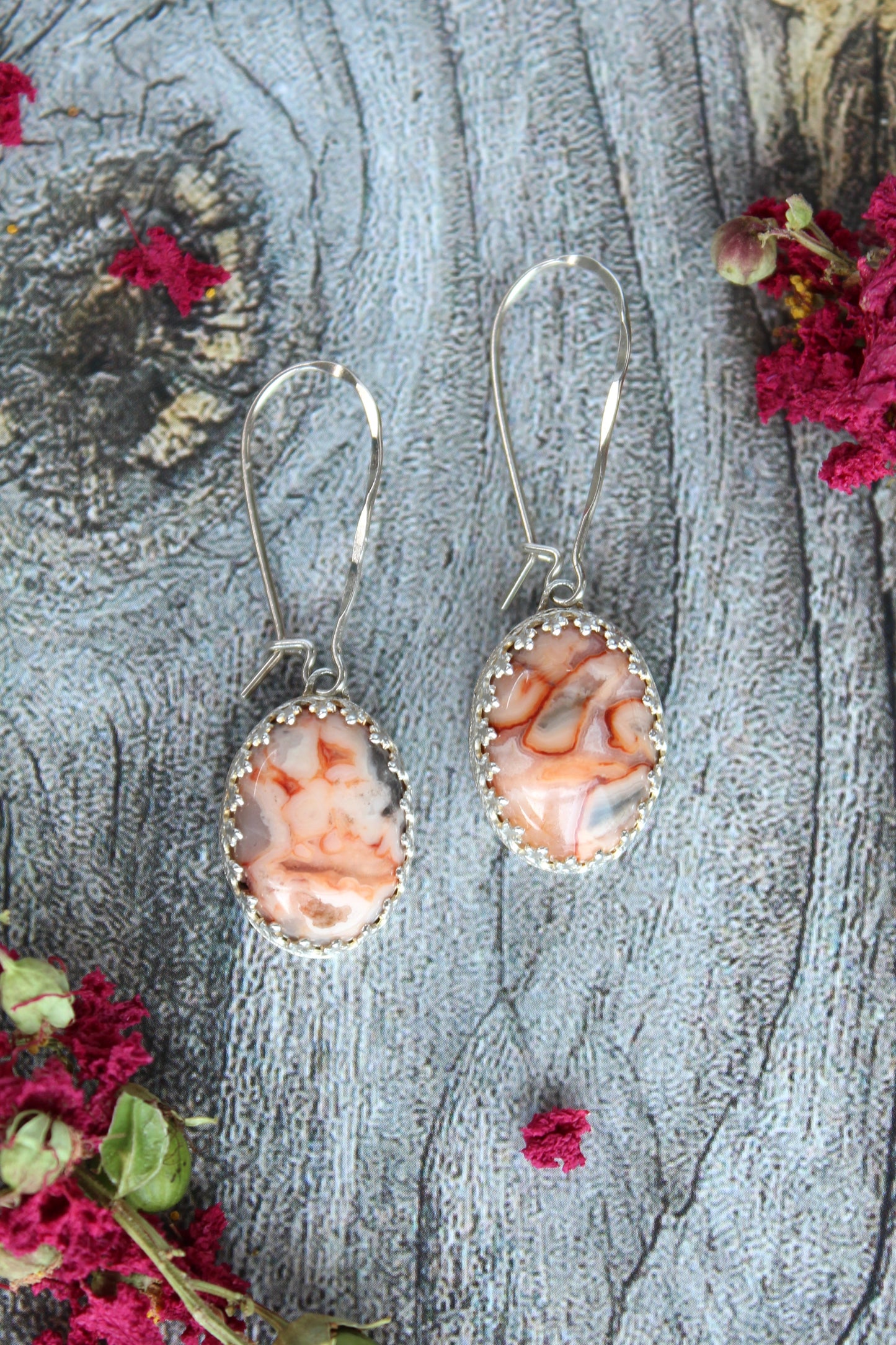 Lace Agate Oval Gemstones in Pink and Gray, set in a patterned sterling silver bezel with long texturized kidney ear wires. Handmade by Cara Carter Jewelry