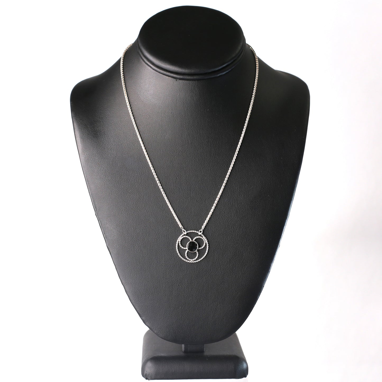 Faceted black onyx gemstone set in a stylized sterling silver floral design on a sterling silver wheat chain. Handmade by Cara Carter Jewelry
