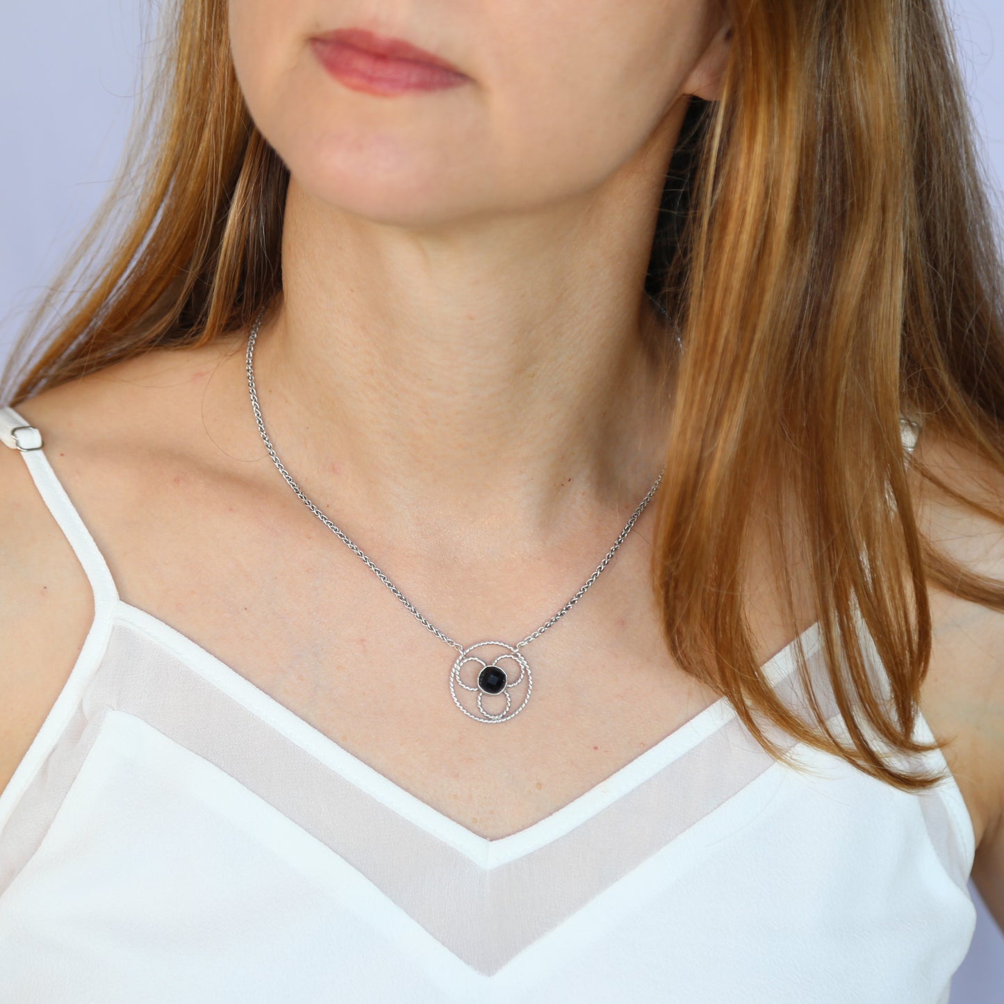 Faceted black onyx gemstone set in a stylized sterling silver floral design on a sterling silver wheat chain. Handmade by Cara Carter Jewelry