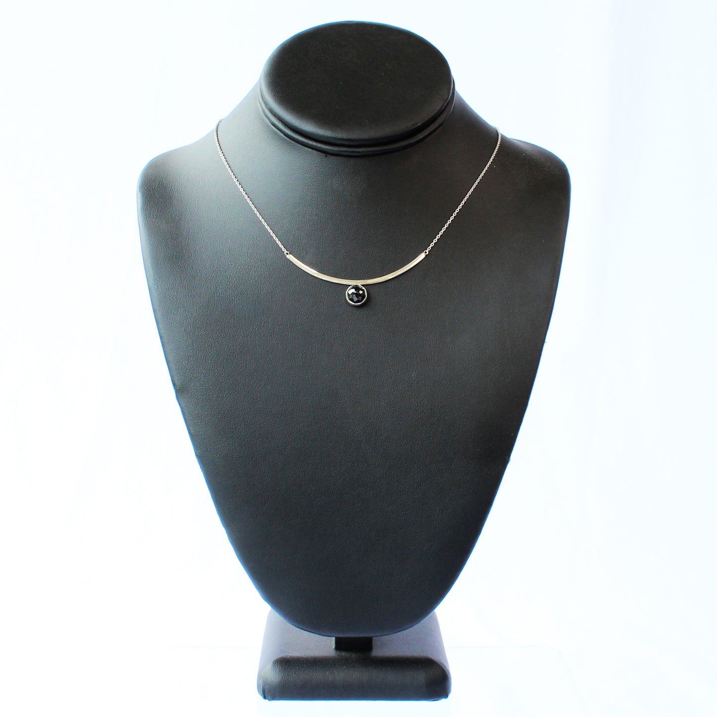 Black Spinel Faceted Gemstone on Minimalist Sterling Silver Curved Bar Necklace. Handmade by Cara Carter Jewelry