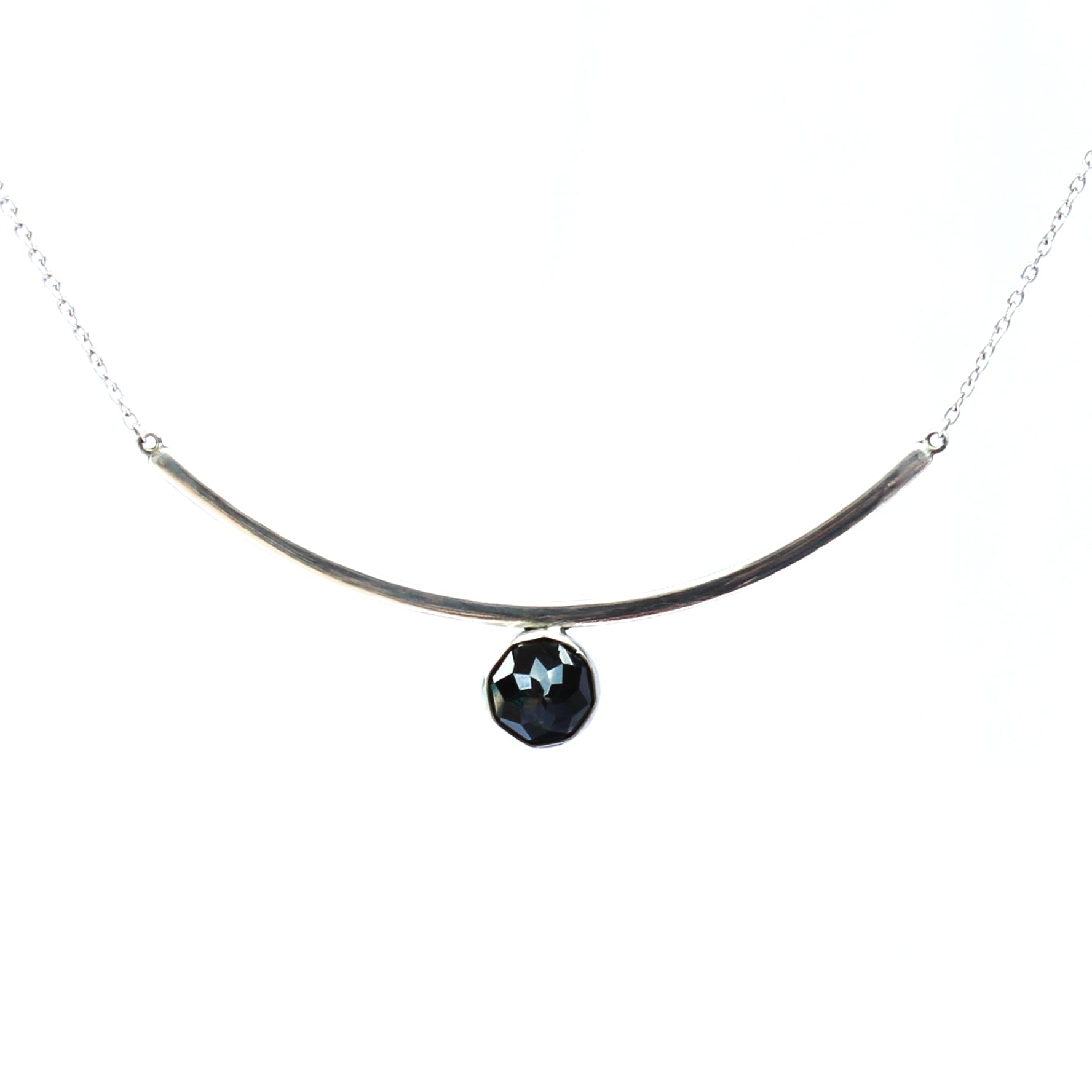 Black Spinel Faceted Gemstone on Minimalist Sterling Silver Curved Bar Necklace. Handmade by Cara Carter Jewelry