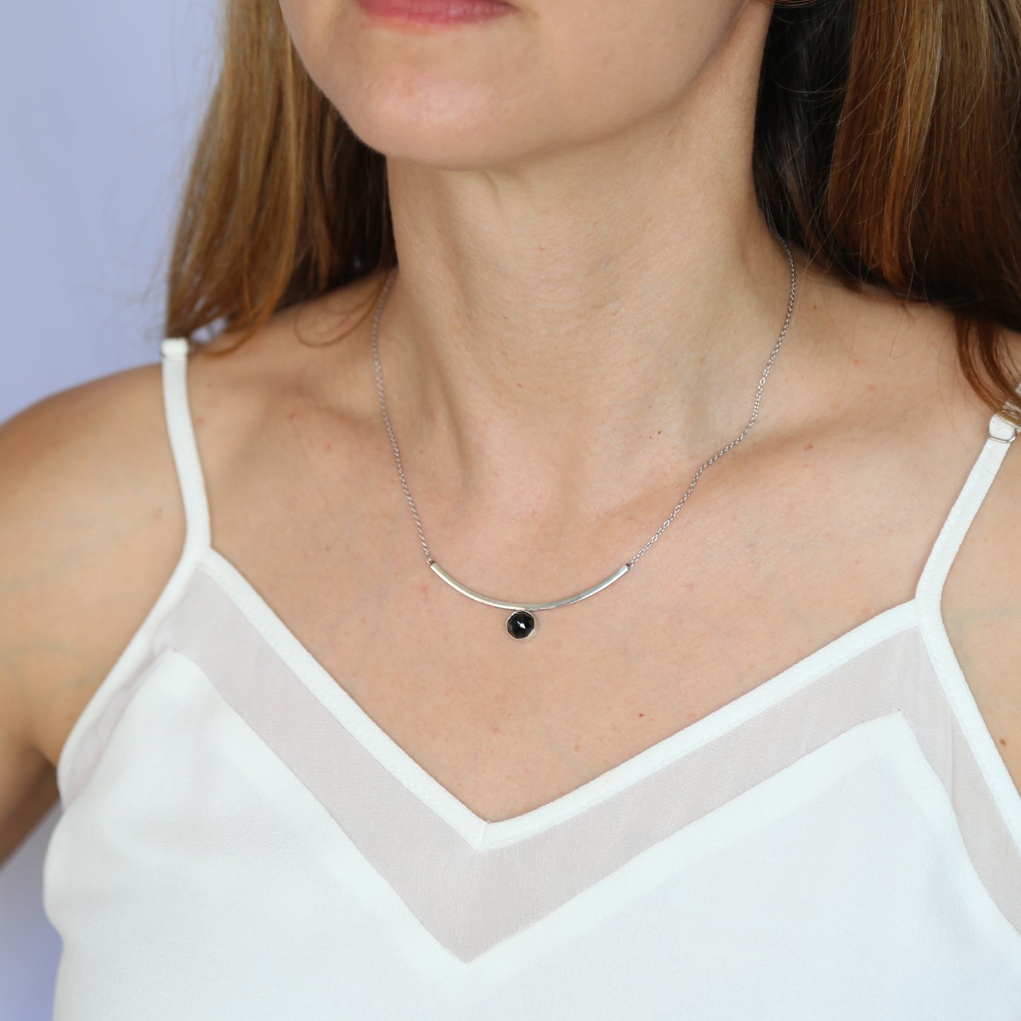 Black Spinel Faceted Gemstone on Minimalist Sterling Silver Curved Bar Necklace. Handmade by Cara Carter Jewelry