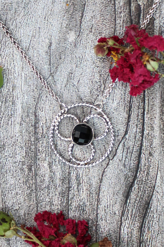 Faceted black onyx gemstone set in a stylized sterling silver floral design on a sterling silver wheat chain. Handmade by Cara Carter Jewelry